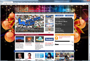 Using the 'white space' outside of the fixed widdth area to include value add graphics. Territory FM website screenshot